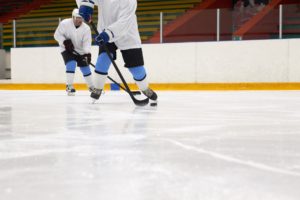 a person playing hockey at an ice rink